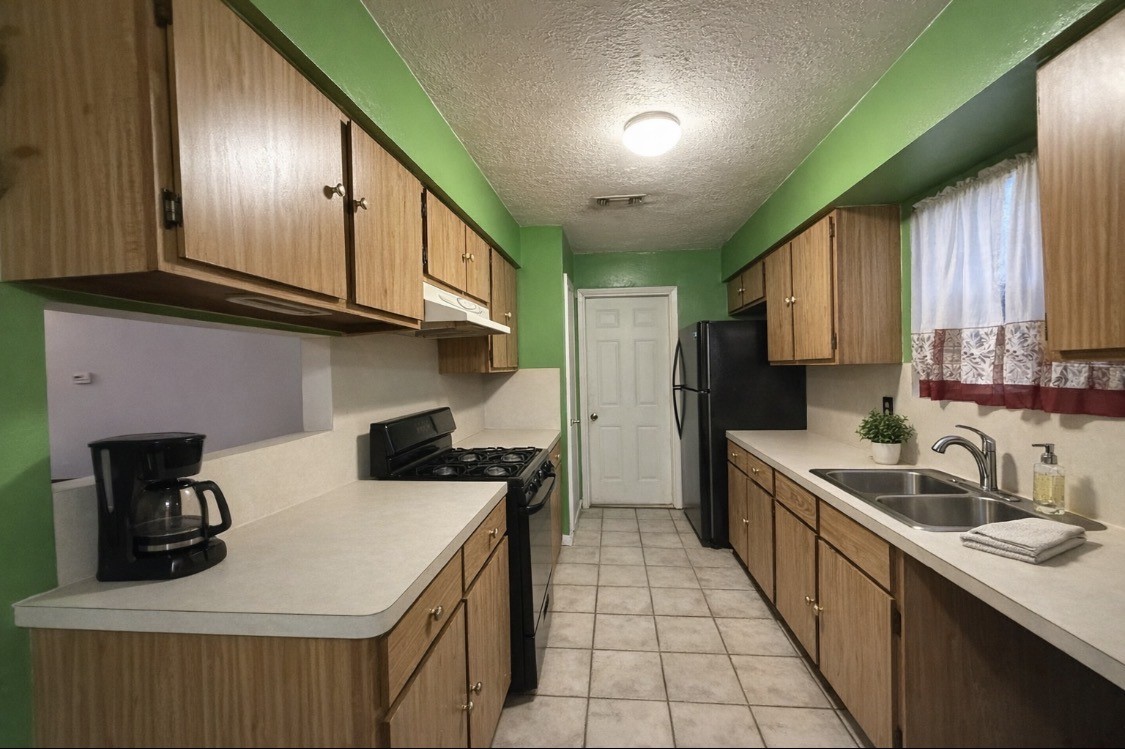 2102 Snowdrop Lane Houston, TX 77067 - Photo 4 of 9 a kitchen that has a sink and a stove