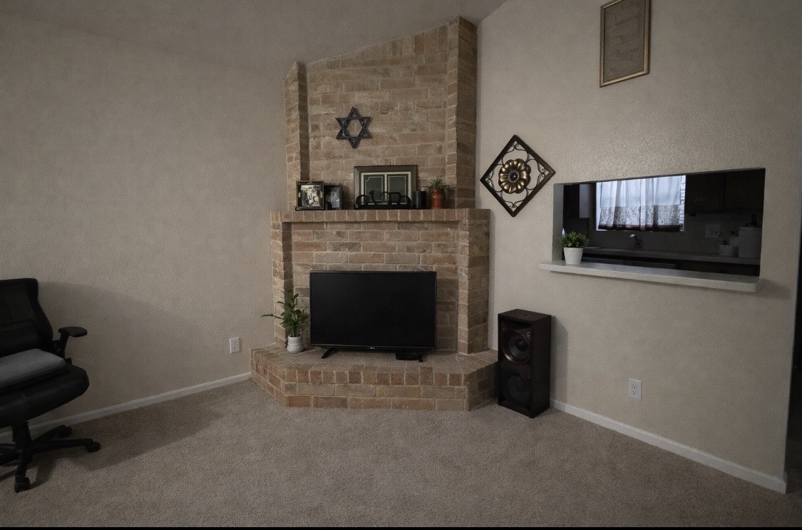 2102 Snowdrop Lane Houston, TX 77067 - Photo 7 of 9 a living room with furniture and a fireplace