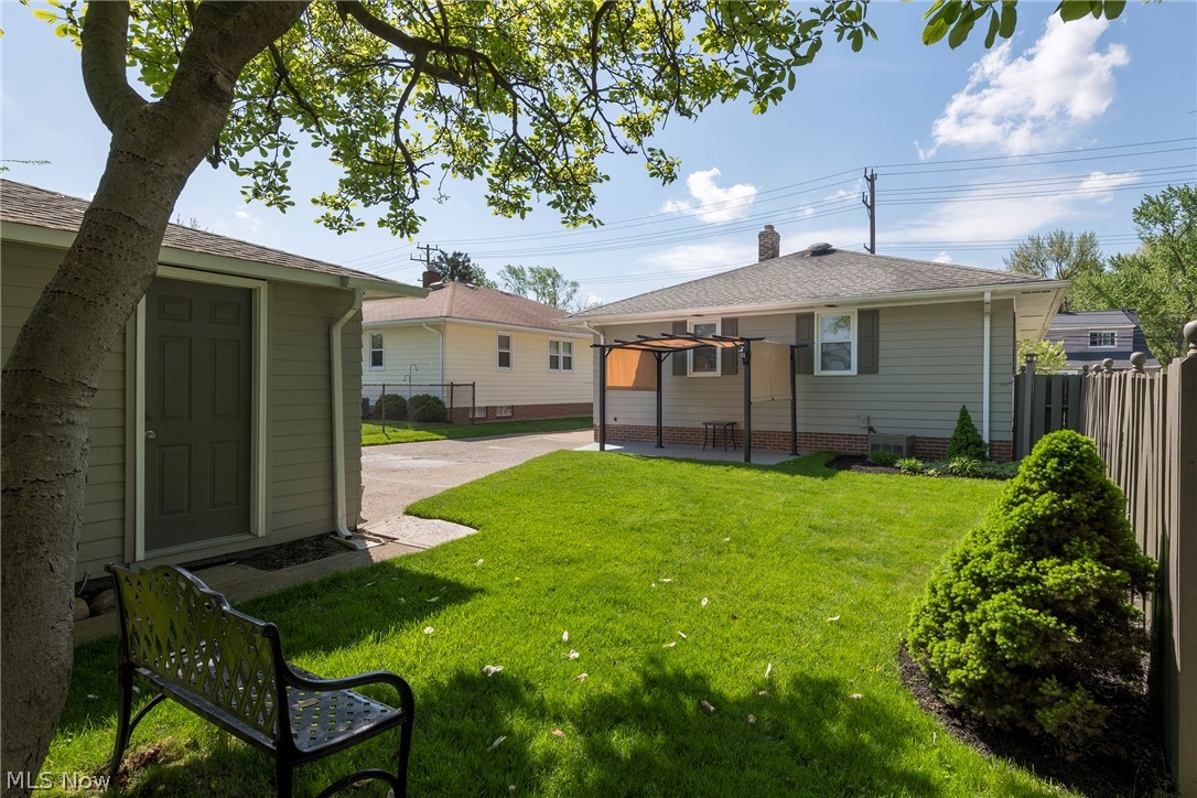 13175 McCracken Road Cleveland, OH 44125 - Photo 39 of 48 Rear view of house with a patio area, a yard, and central AC
