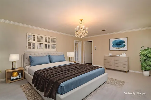 a front view of a house with a garden and plants