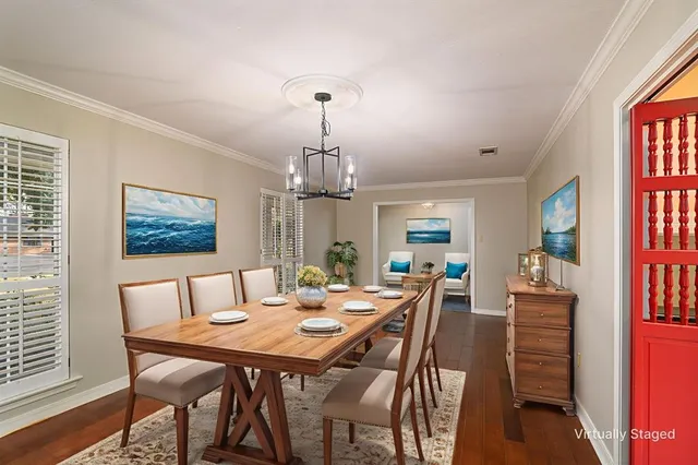 a view of a livingroom with a ceiling fan window and wooden floor