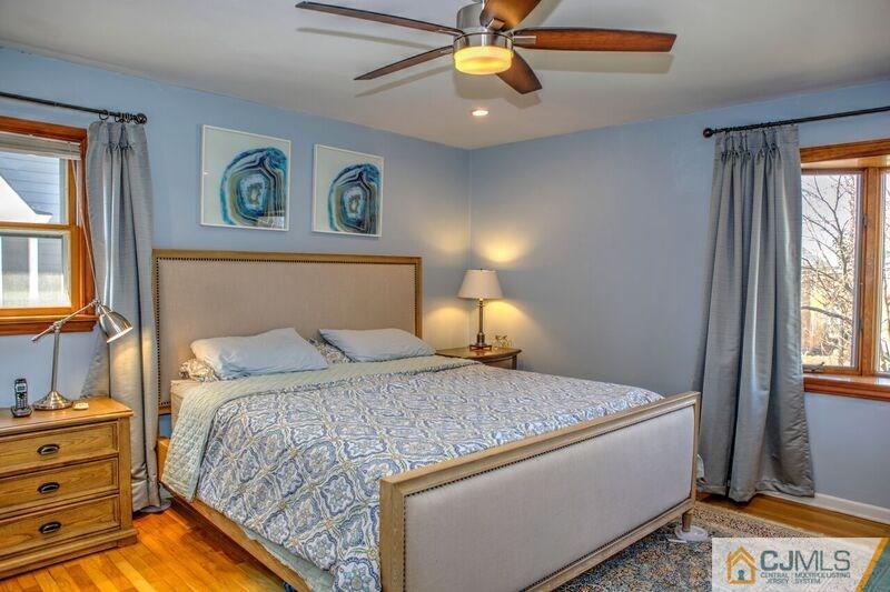 36 Edgewood Road Edison, NJ 08820 - Photo 13 of 23 a bedroom with a bed and a chandelier