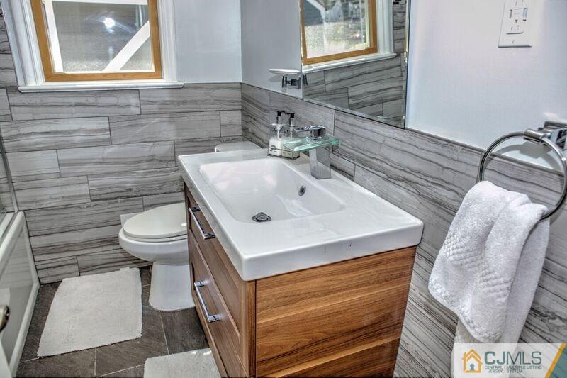 36 Edgewood Road Edison, NJ 08820 - Photo 20 of 23 a bathroom with a sink a toilet and mirror