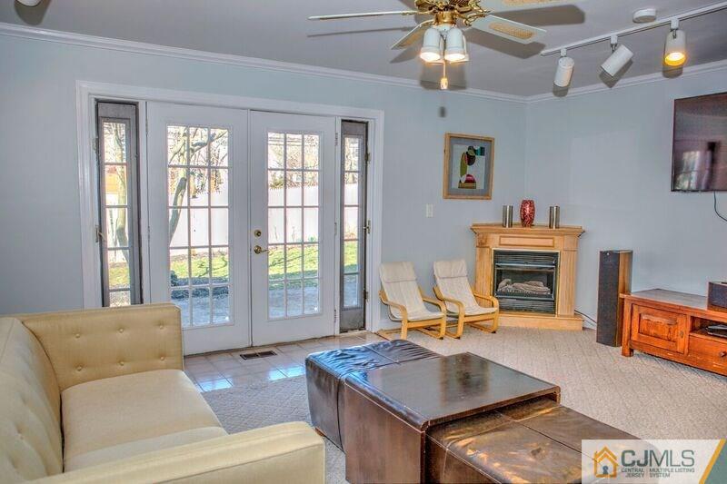 36 Edgewood Road Edison, NJ 08820 - Photo 8 of 23 a living room with furniture a fireplace and a chandelier