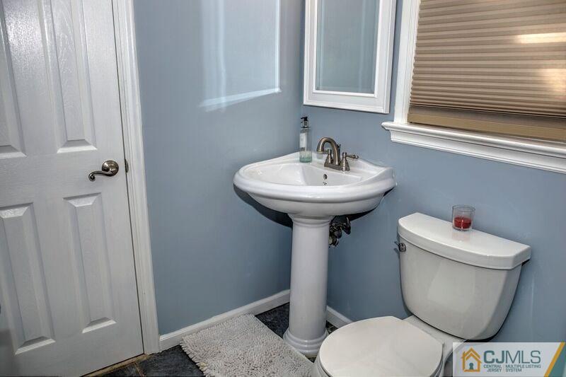 36 Edgewood Road Edison, NJ 08820 - Photo 9 of 23 a bathroom with a toilet sink and mirror