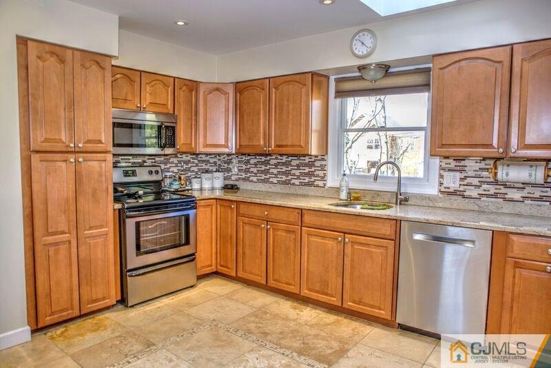 36 Edgewood Road Edison, NJ 08820 - Photo 10 of 23 a kitchen with stainless steel appliances granite countertop a sink stove refrigerator and cabinets