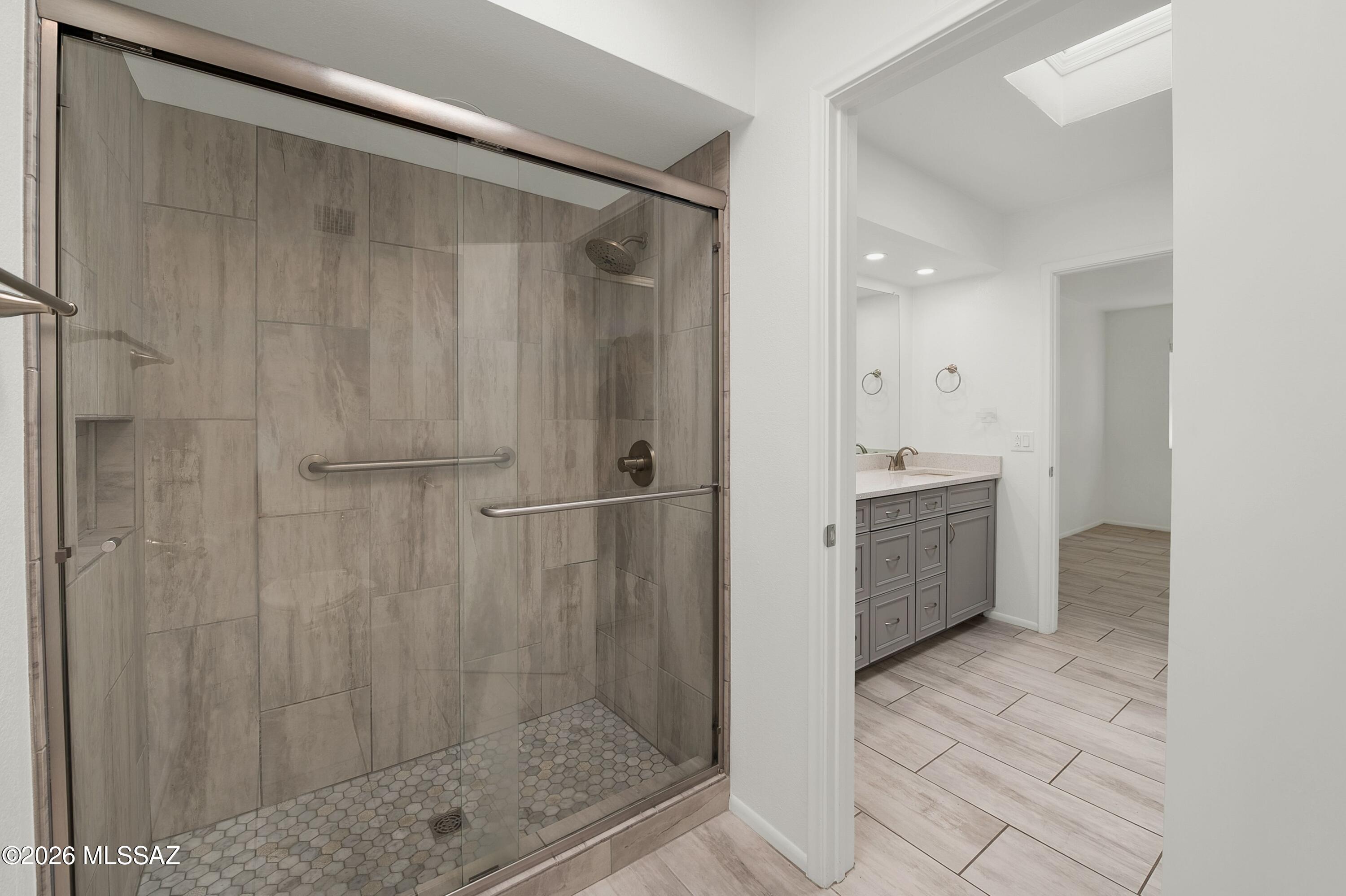 7408 East Wandering Road Tucson, AZ 85750 - Photo 17 of 25 a bathroom with a shower and a sink