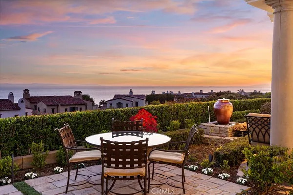 a view of a patio with couches and table and chairs and potted plants