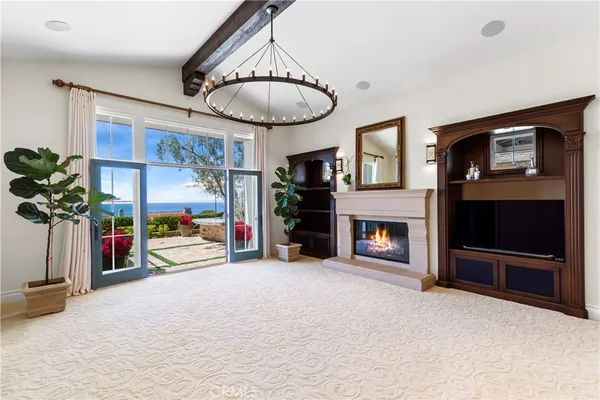 a dining room with furniture a rug and a chandelier