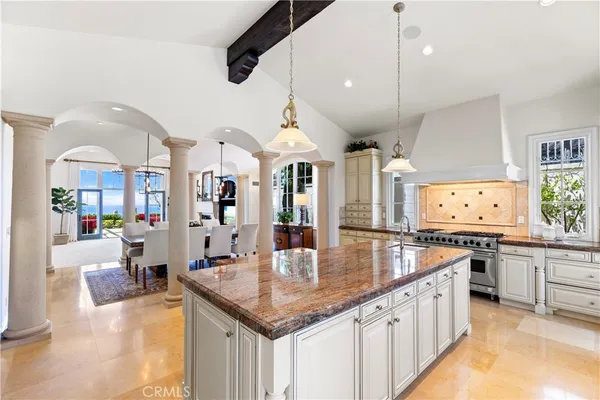 a kitchen with stainless steel appliances granite countertop a stove and a refrigerator