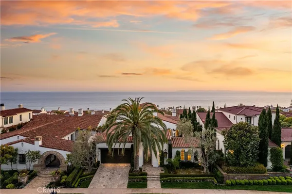 a front view of a house with lots of yellow lighting