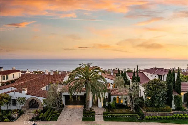 a front view of a house with lots of yellow lighting