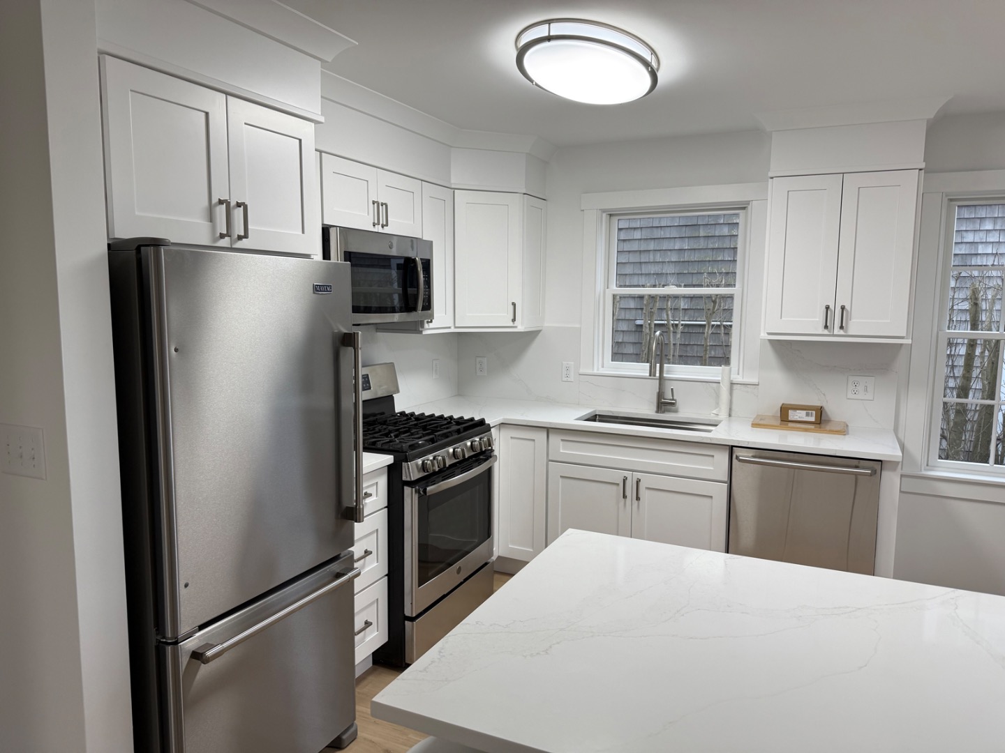 106 Old South Road, Unit A B Nantucket, MA 02554 - Photo 7 of 24 a kitchen with stainless steel appliances granite countertop a refrigerator stove top oven and sink