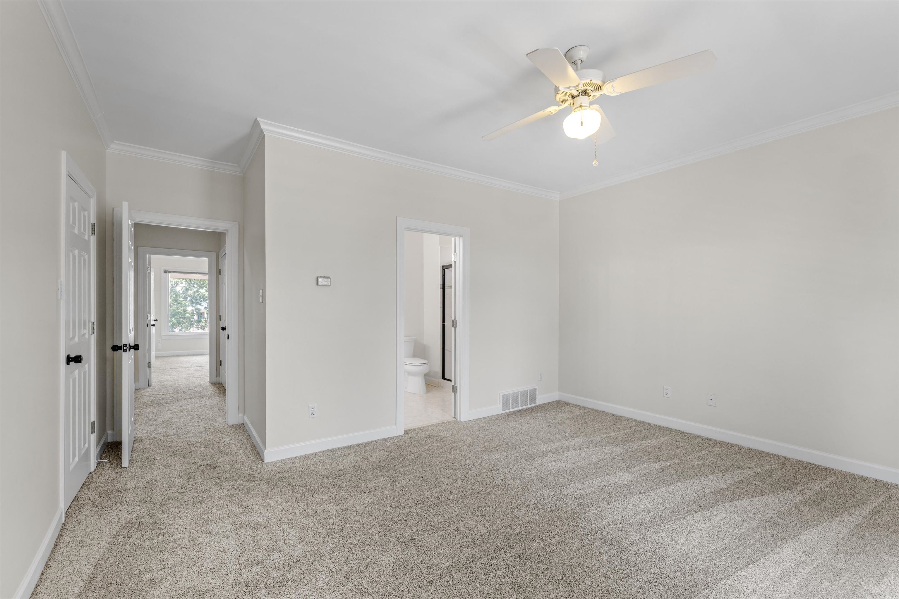 921 Harbor View Drive Memphis, TN 38103 - Photo 24 of 33 Spacious room featuring plush carpeting, crown molding, a ceiling fan with integrated lighting, and multiple doorways providing access to additional areas