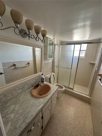 a bathroom with a sink a toilet a mirror and vanity