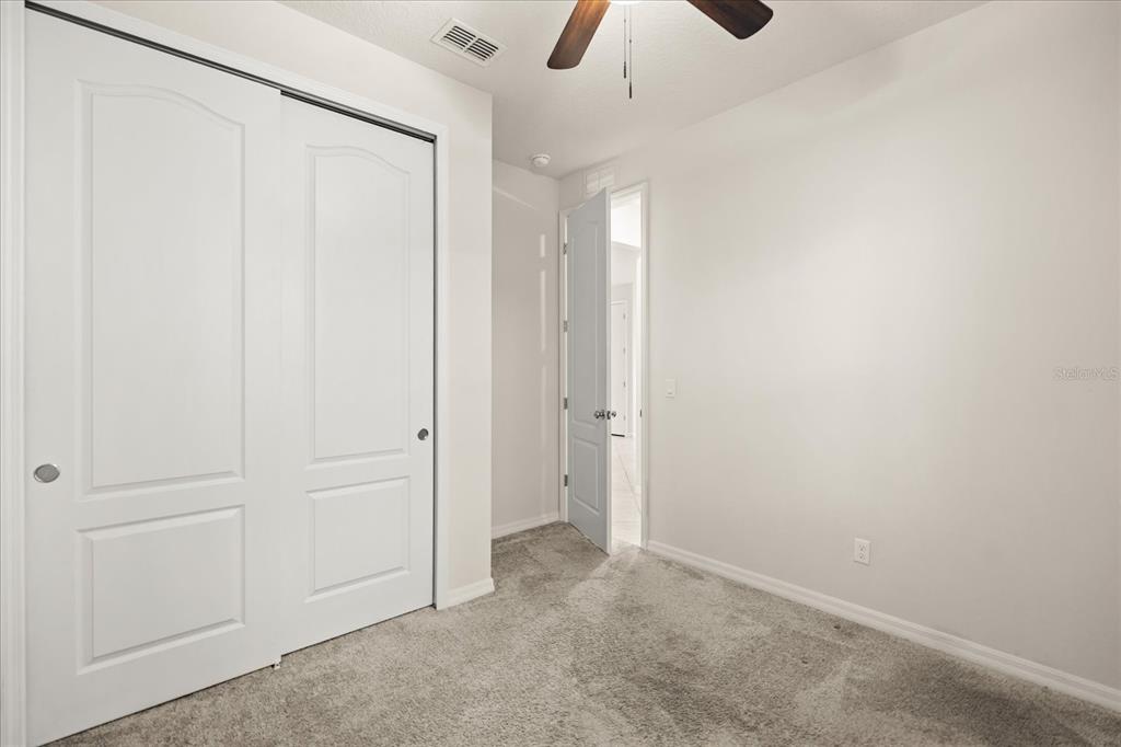 5192 Chickadee Street St. Cloud, FL 34771 - Photo 12 of 35 wooden floor in an empty room