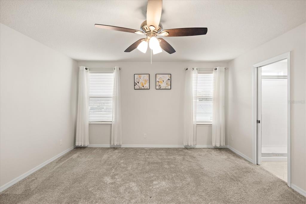 5192 Chickadee Street St. Cloud, FL 34771 - Photo 20 of 35 an empty room with fan and windows