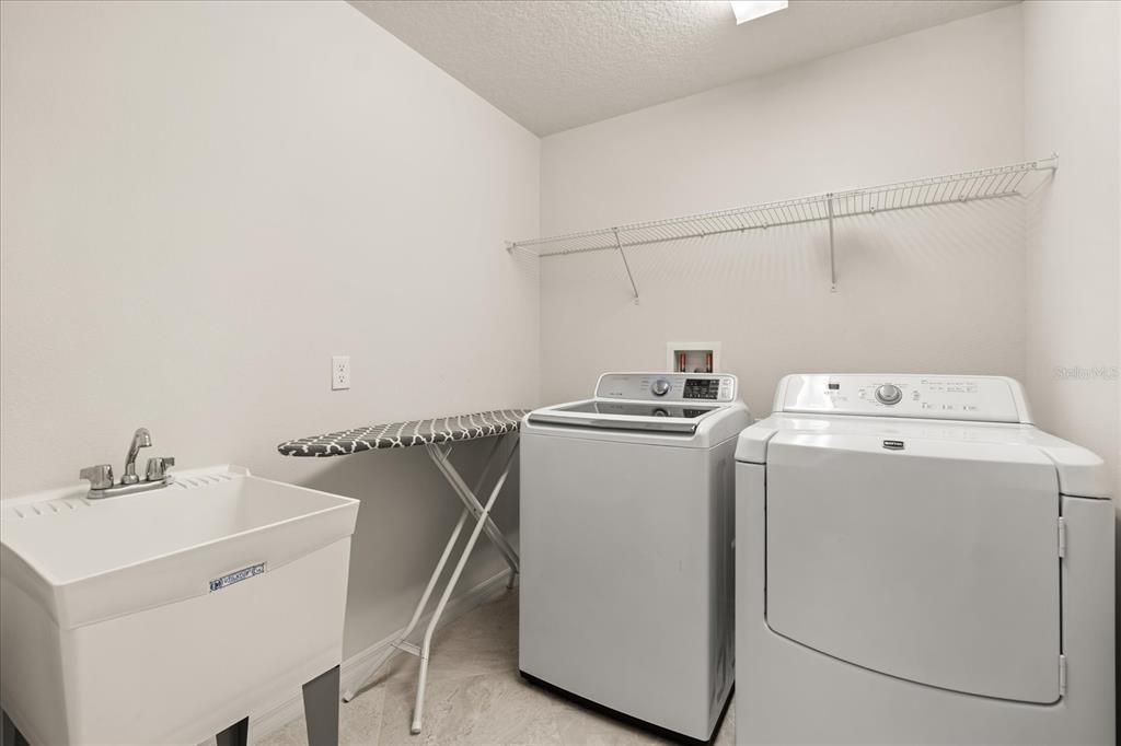5192 Chickadee Street St. Cloud, FL 34771 - Photo 29 of 35 a utility room with dryer and washer