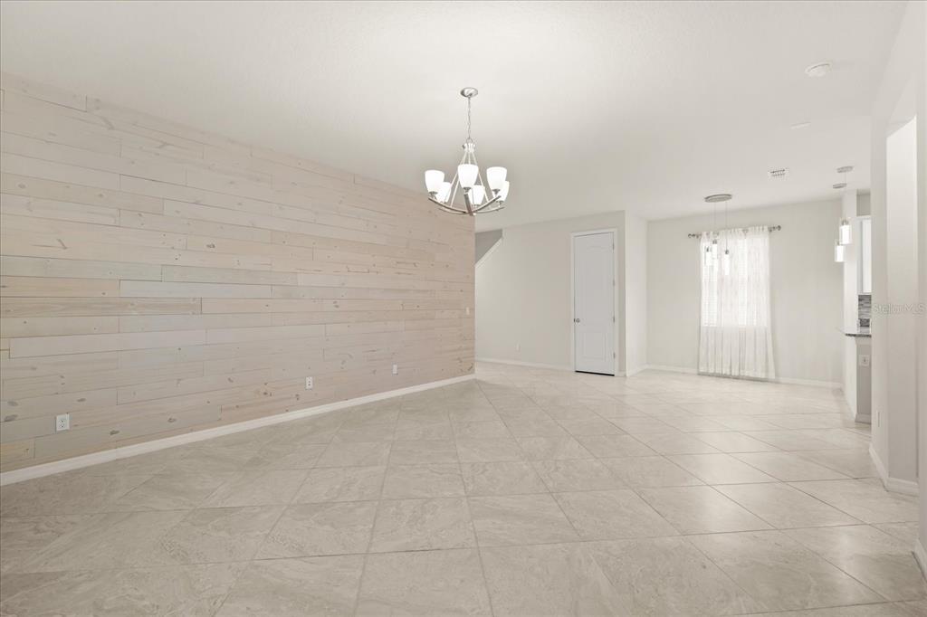 5192 Chickadee Street St. Cloud, FL 34771 - Photo 5 of 35 wooden floor in an empty room with a window