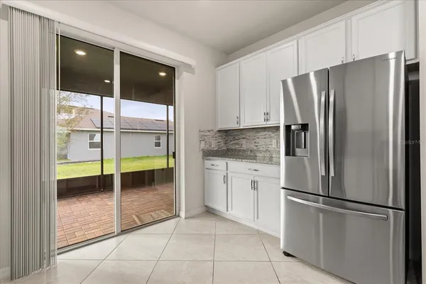 a kitchen with a refrigerator and a sink
