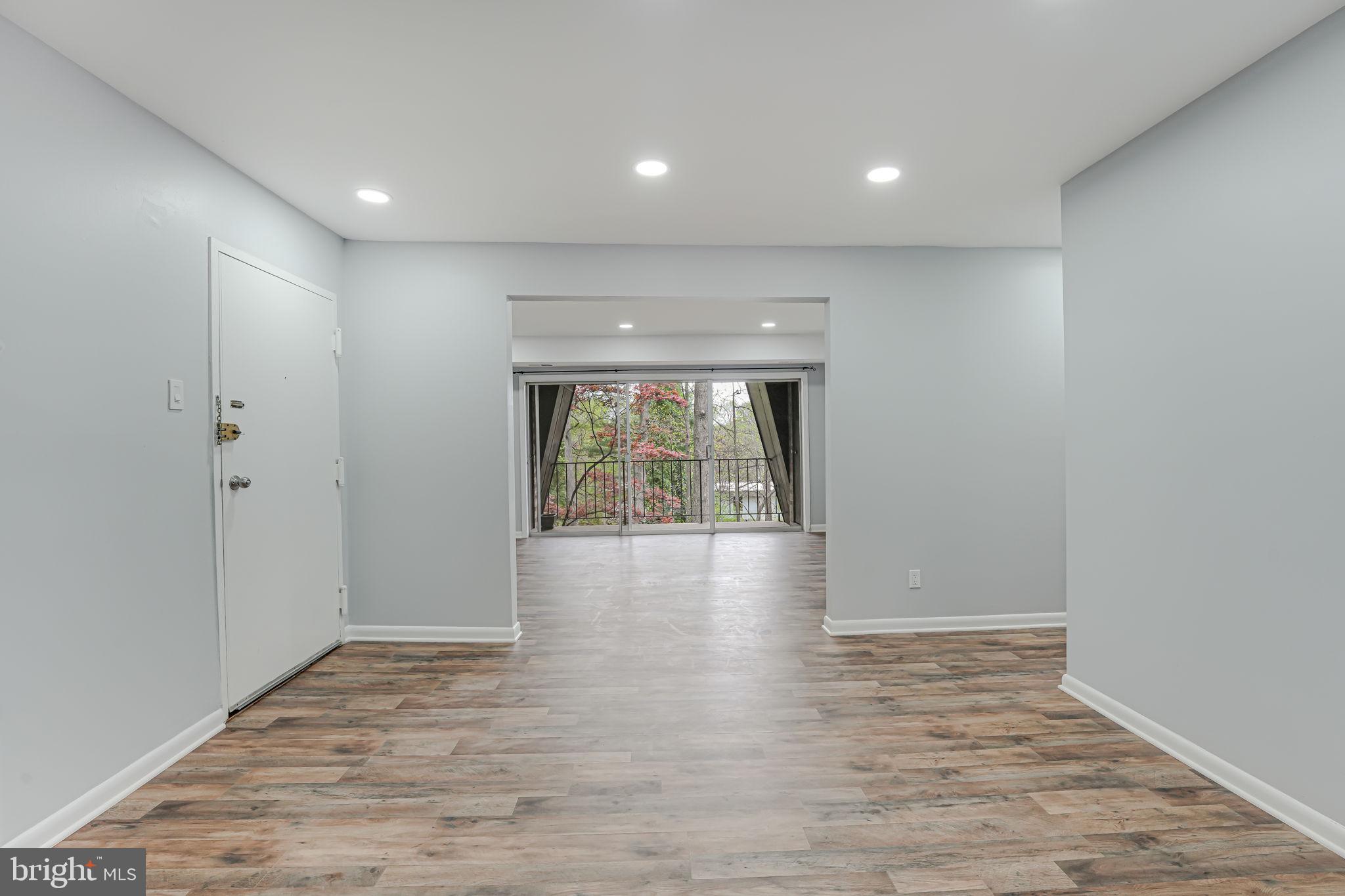 11601 Vantage Hill Road, Unit 22B Reston, VA 20190 - Photo 13 of 37 View from kitchen into living space leads to bal.