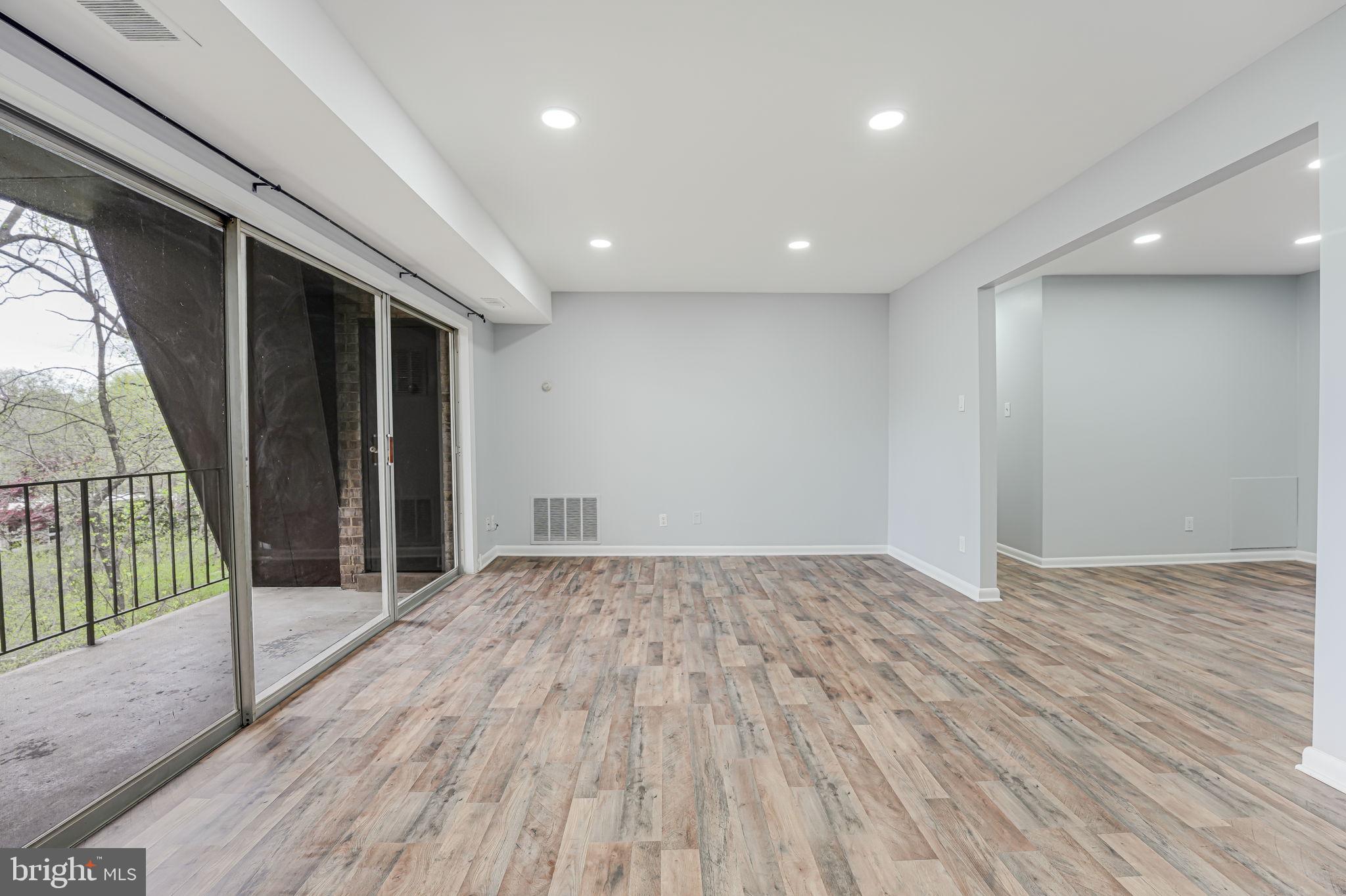11601 Vantage Hill Road, Unit 22B Reston, VA 20190 - Photo 6 of 37 Open living space leads to balcony.