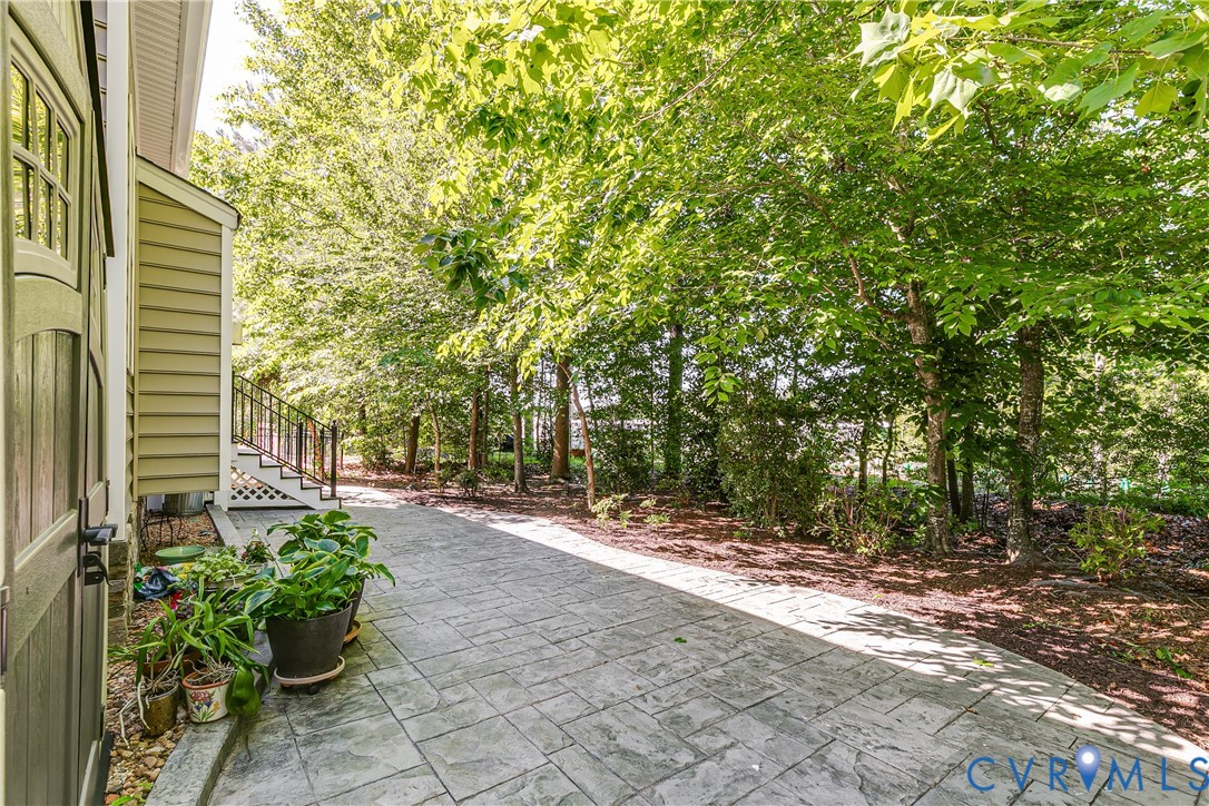 7538 South Franklins Way Quinton, VA 23141 - Photo 40 of 48 a view of a backyard with potted plants and large trees