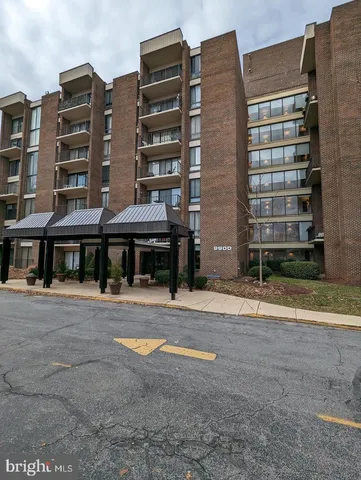 a front view of a building with a yard