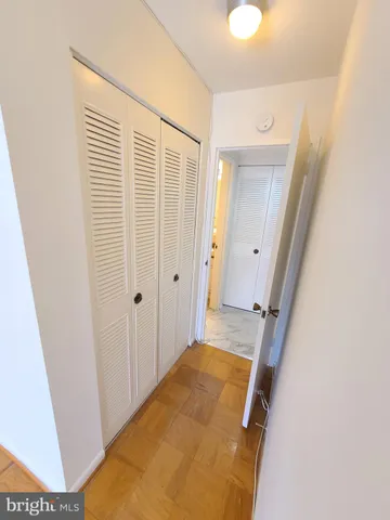 a view of a hallway with wooden floor and entryway