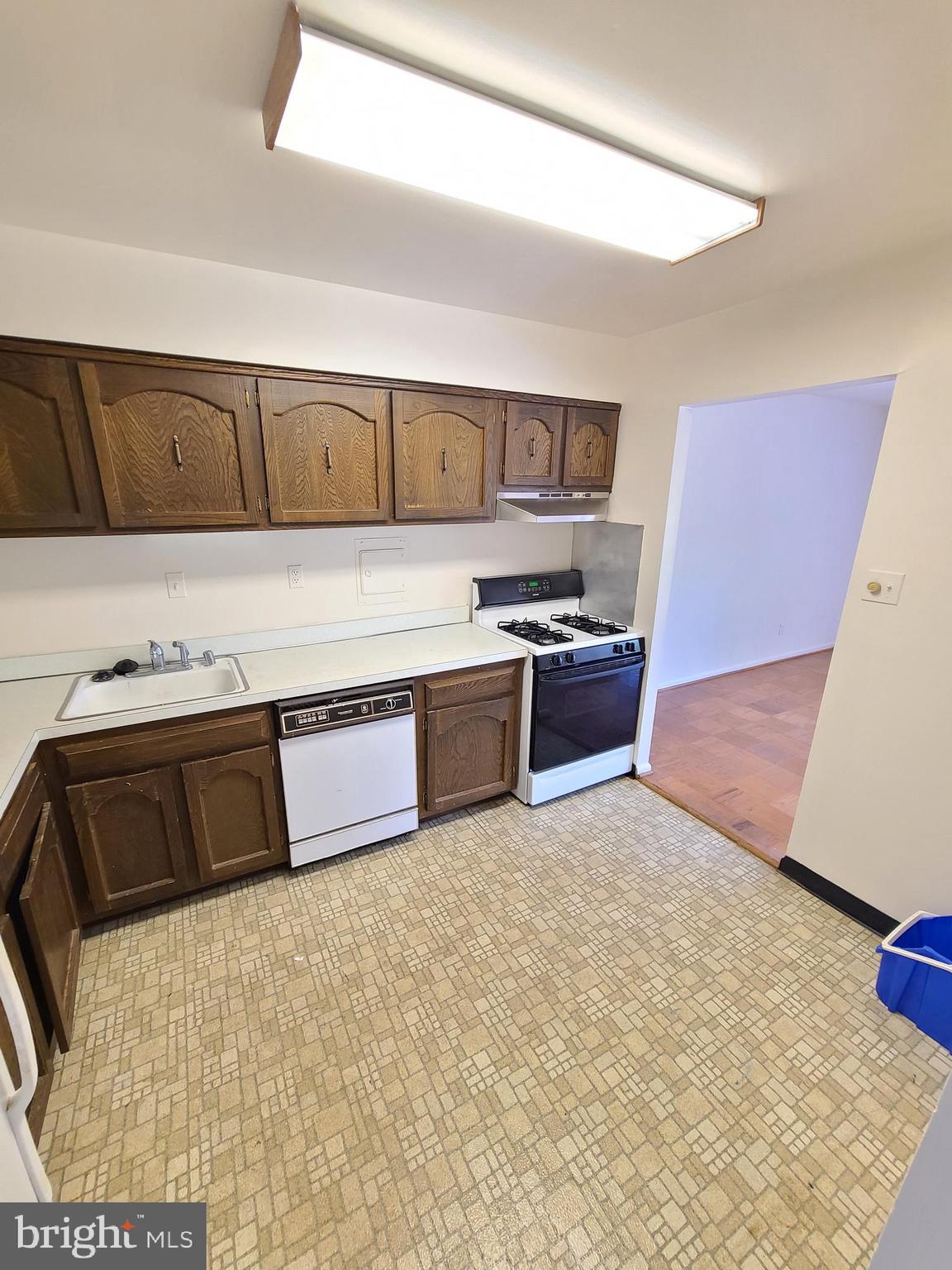 9900 Georgia Avenue, Unit 310 Silver Spring, MD 20902 - Photo 12 of 16 a kitchen with stainless steel appliances a stove a sink and a refrigerator