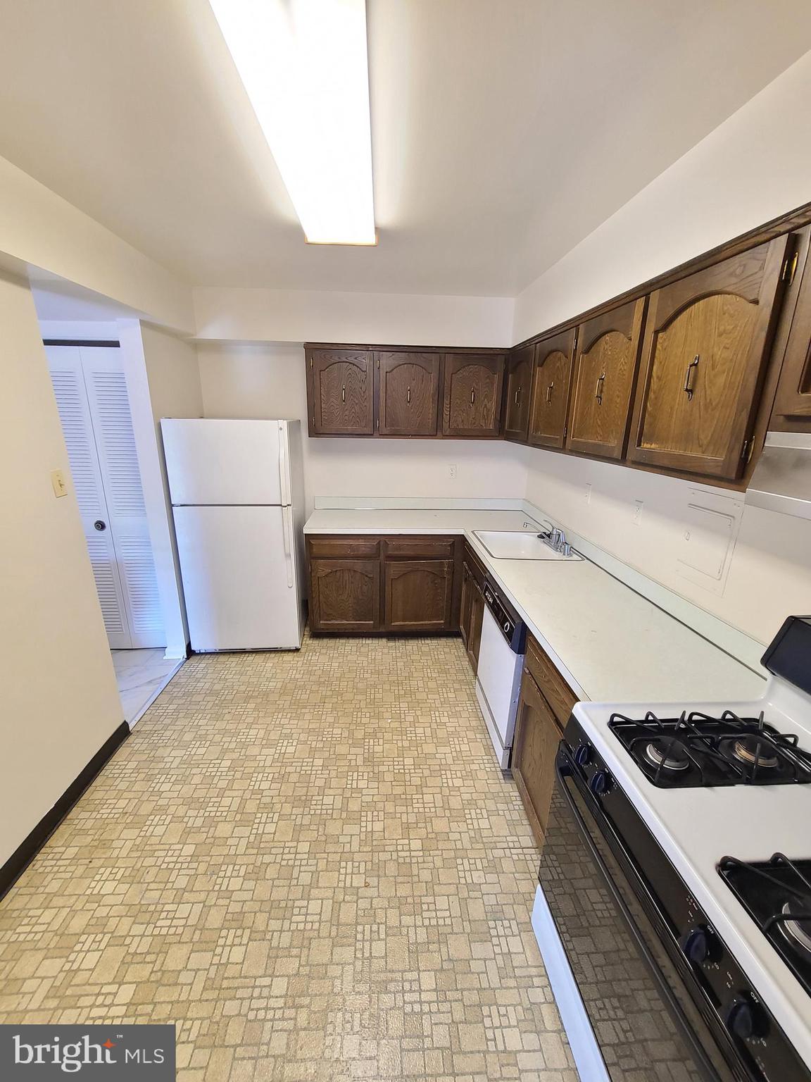 9900 Georgia Avenue, Unit 310 Silver Spring, MD 20902 - Photo 13 of 16 a hallway with washer and dryer