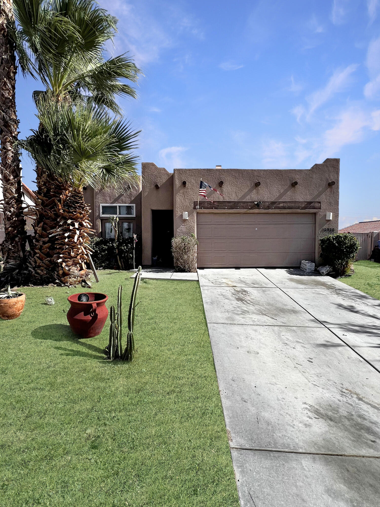 12928 Agua Cayendo Road Desert Hot Springs, CA 92240 - Photo 16 of 21 a front view of a house with a garden