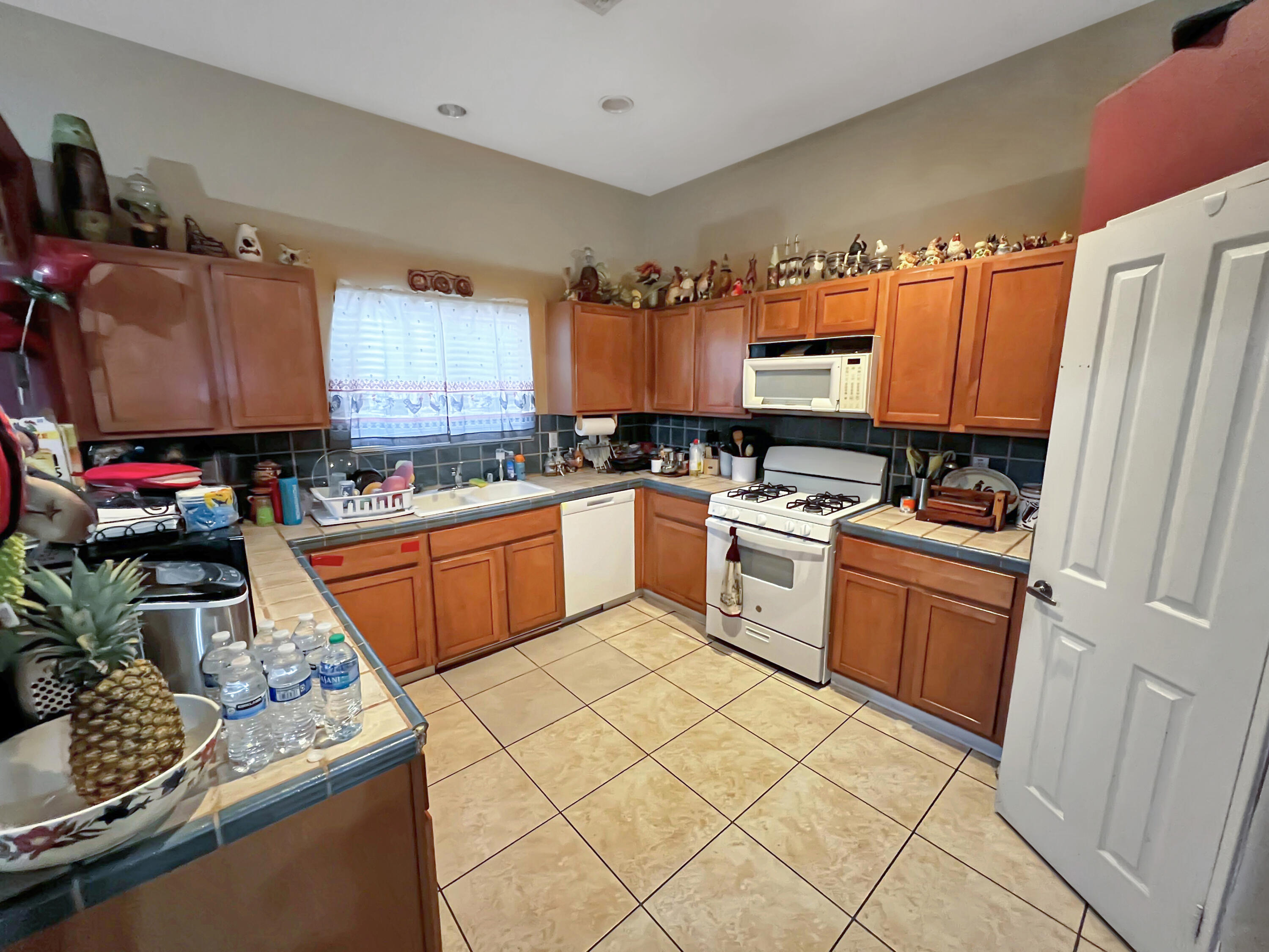 12928 Agua Cayendo Road Desert Hot Springs, CA 92240 - Photo 5 of 21 a kitchen with stainless steel appliances granite countertop a sink stove and refrigerator