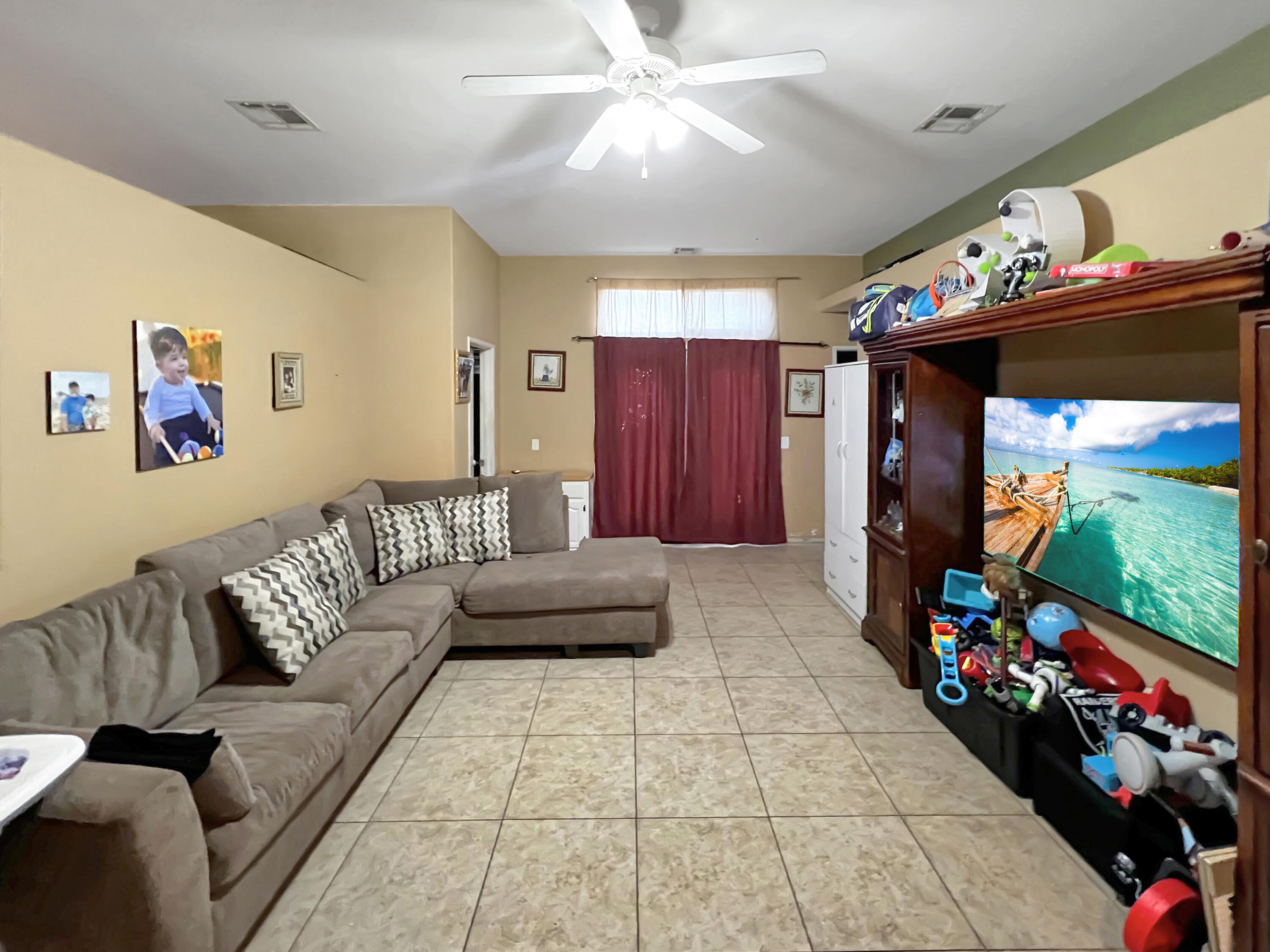 12928 Agua Cayendo Road Desert Hot Springs, CA 92240 - Photo 8 of 21 a living room with furniture and a flat screen tv