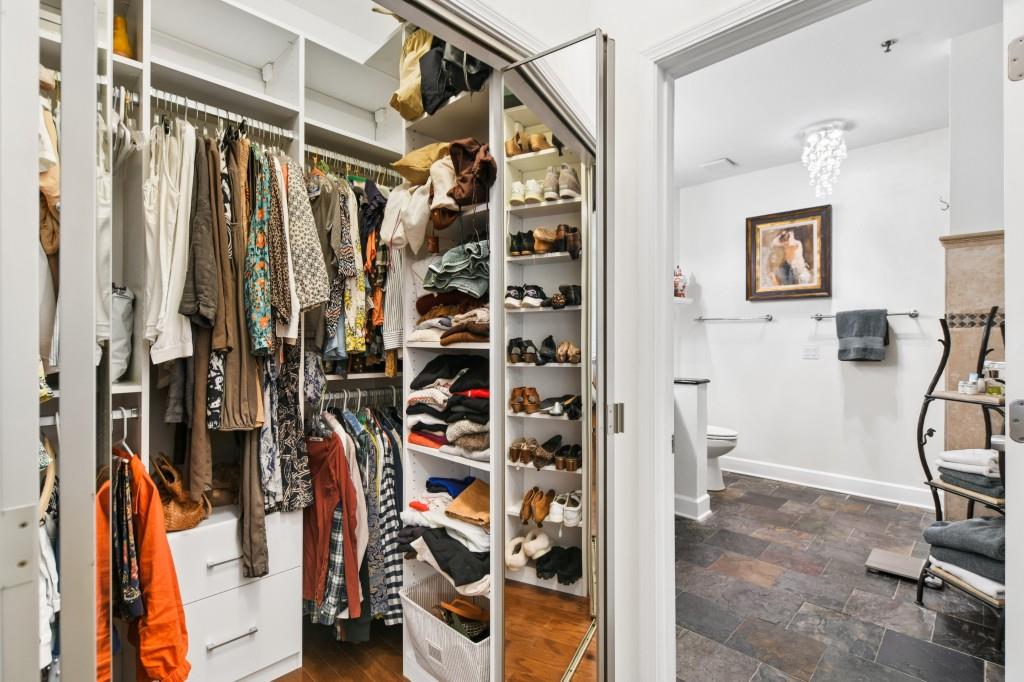 2921 Lenox Road Northeast, Unit 103 Atlanta, GA 30324 - Photo 21 of 37 a view of walk in closet with clothes and shoes