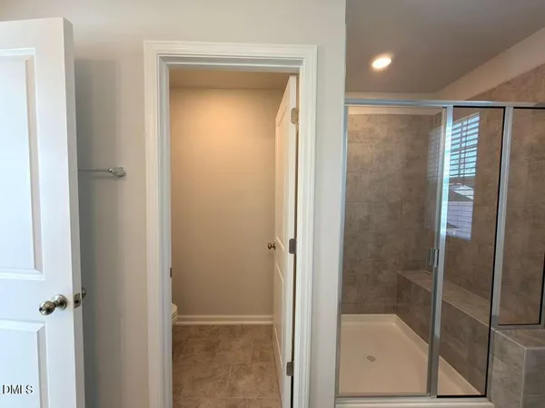 a bathroom with a glass shower door