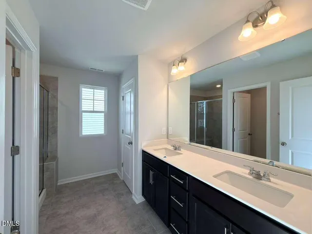 a bathroom with a double vanity sink mirror and double