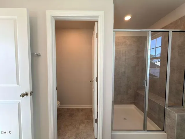 a bathroom with a glass shower door