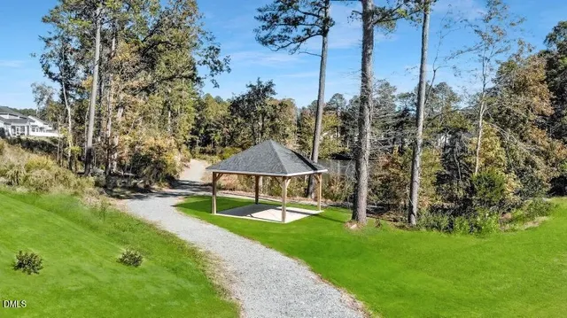 a view of a house with backyard and a tree