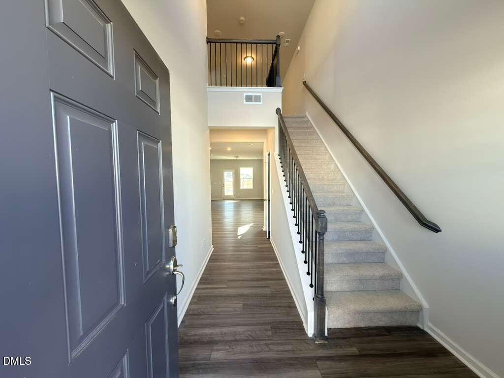 2007 English Saddle Lane Durham, NC 27703 - Photo 4 of 45 a view of staircase with lots of frames on wall and wooden floor