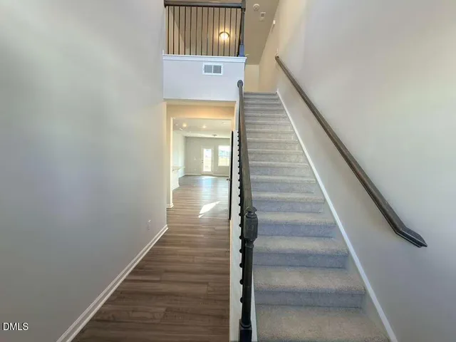 a view of entryway and hall with wooden floor