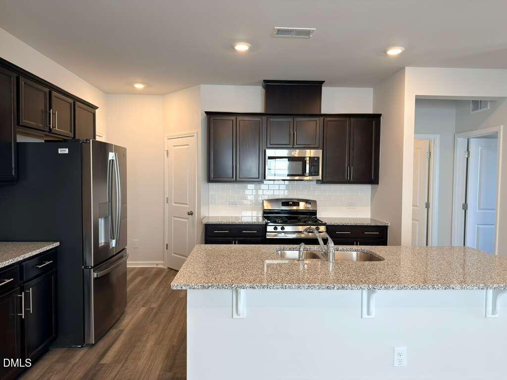 2007 English Saddle Lane Durham, NC 27703 - Photo 6 of 45 a kitchen with a refrigerator a microwave a sink and stove