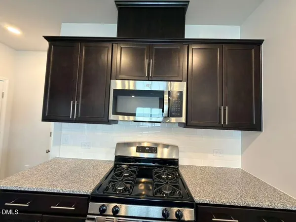 a kitchen with granite countertop stainless steel appliances and cabinets