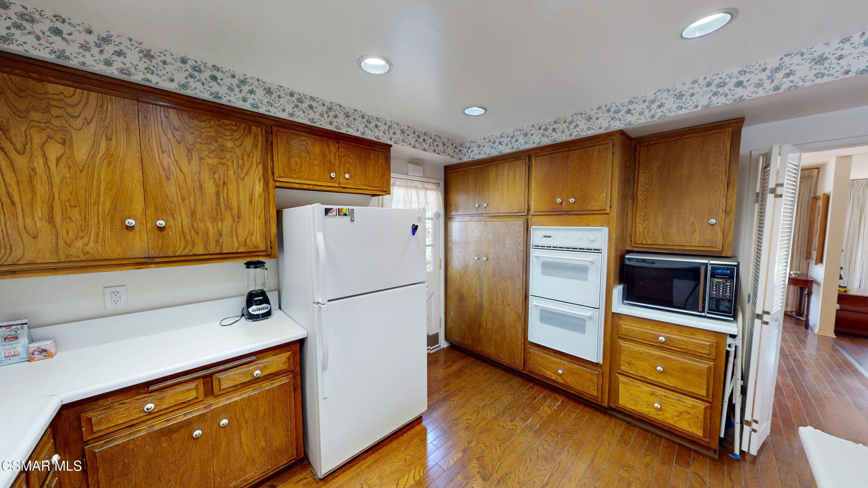 10900 Des Moines Avenue Porter Ranch, CA 91326 - Photo 14 of 38 a kitchen with stainless steel appliances a refrigerator and a stove