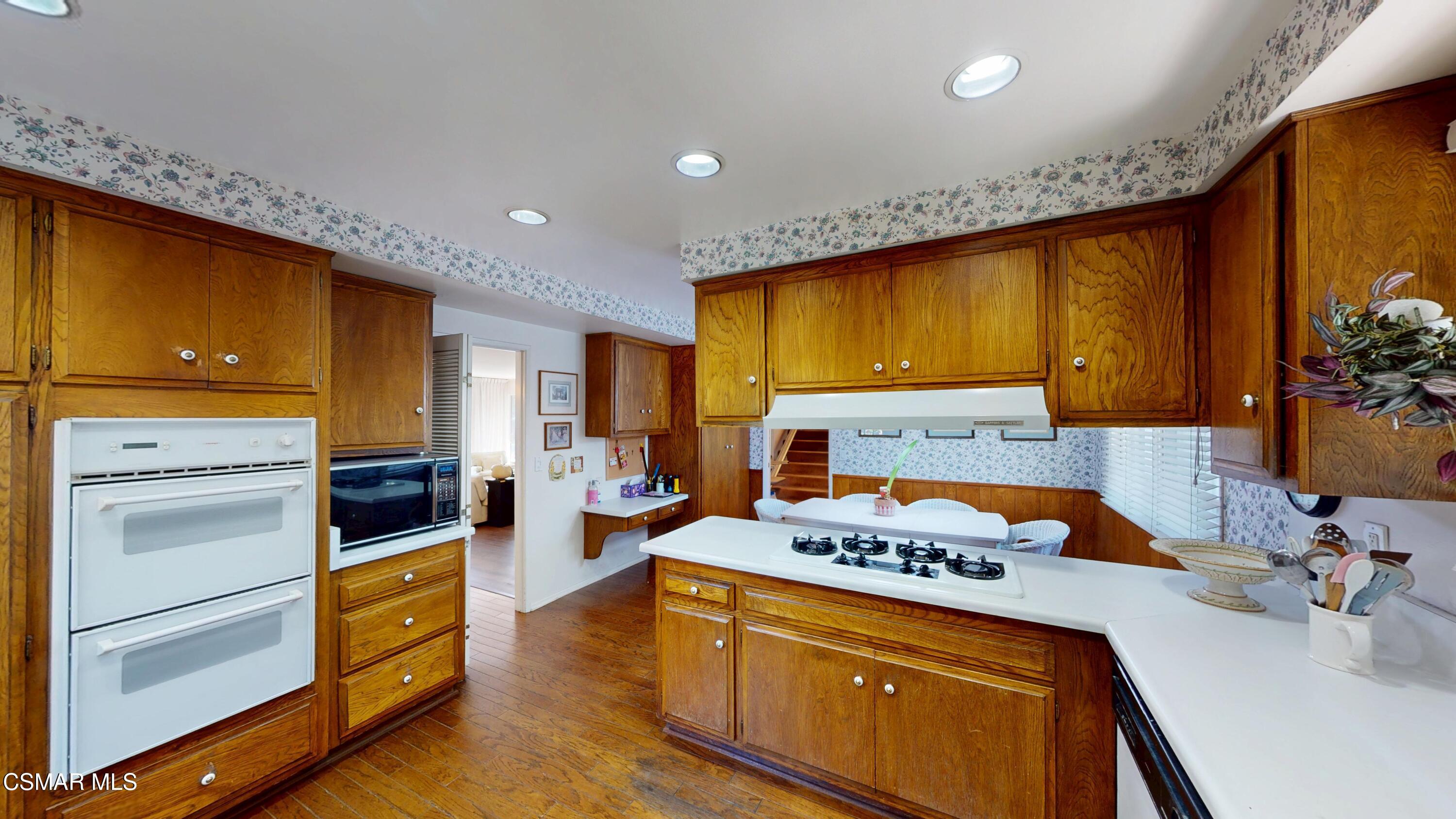 10900 Des Moines Avenue Porter Ranch, CA 91326 - Photo 15 of 38 a kitchen with stainless steel appliances granite countertop a stove a sink and a refrigerator