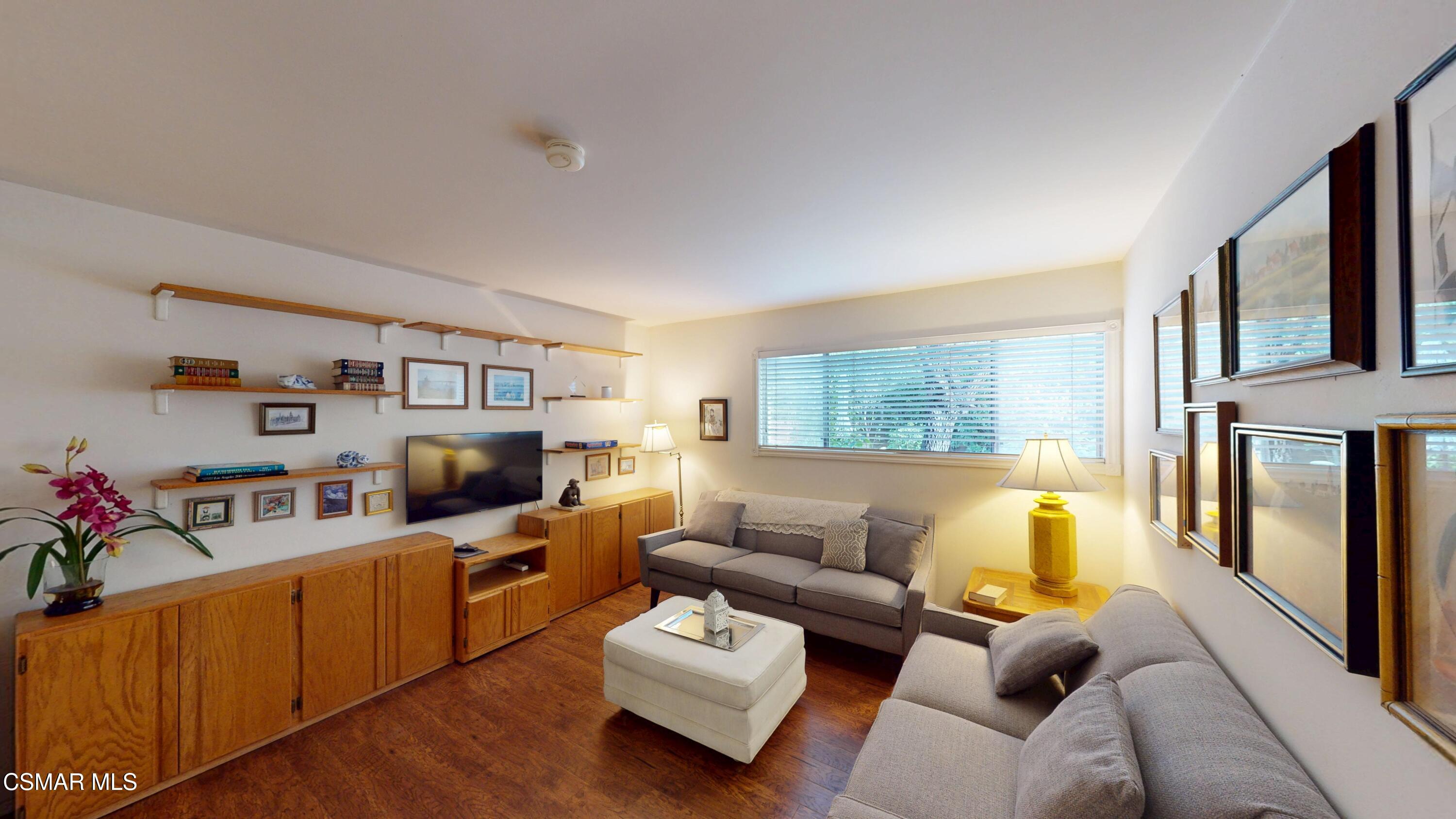 10900 Des Moines Avenue Porter Ranch, CA 91326 - Photo 18 of 38 a living room with furniture flat screen tv and a couch