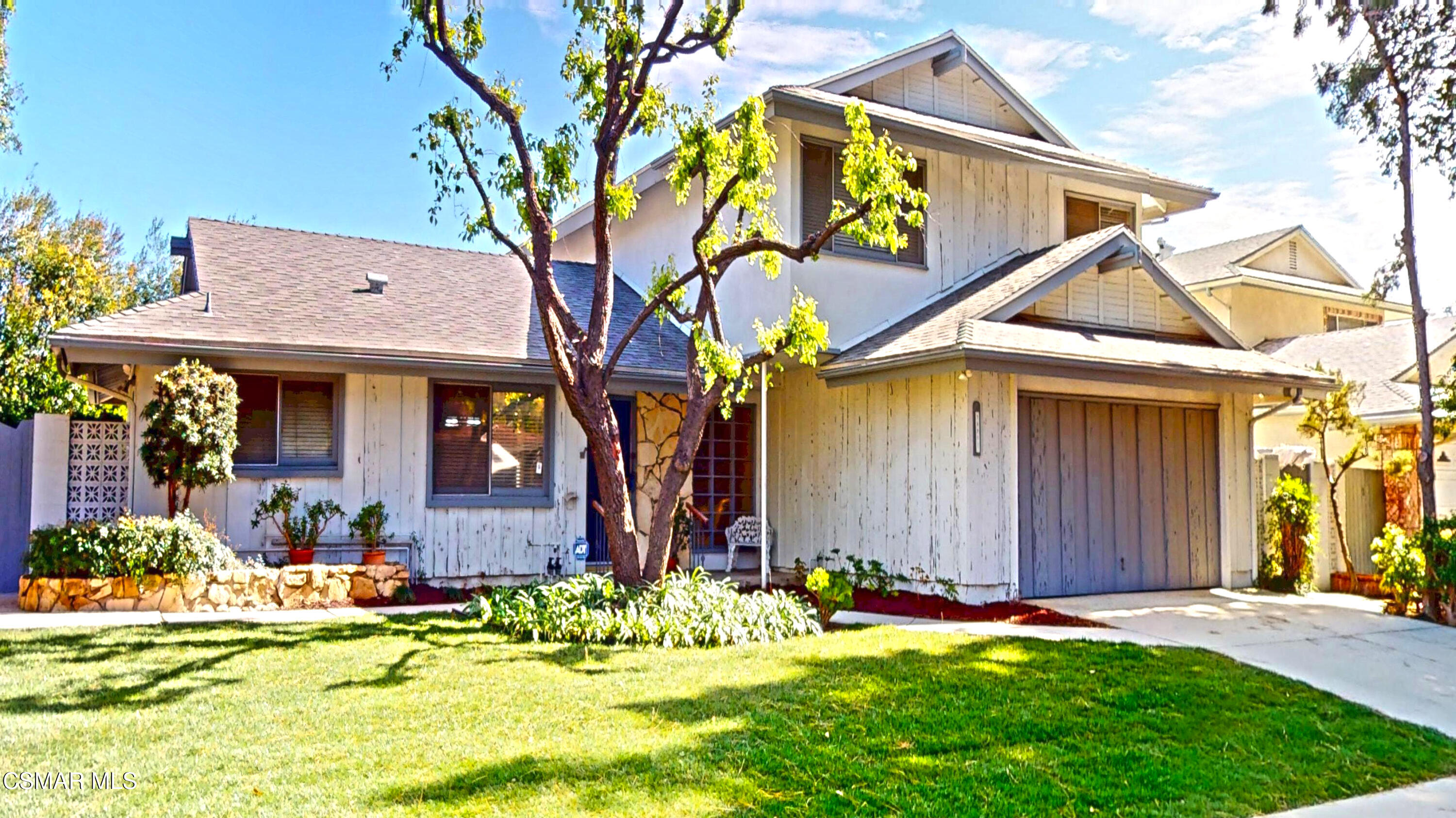 10900 Des Moines Avenue Porter Ranch, CA 91326 - Photo 2 of 38 a front view of a house with garden