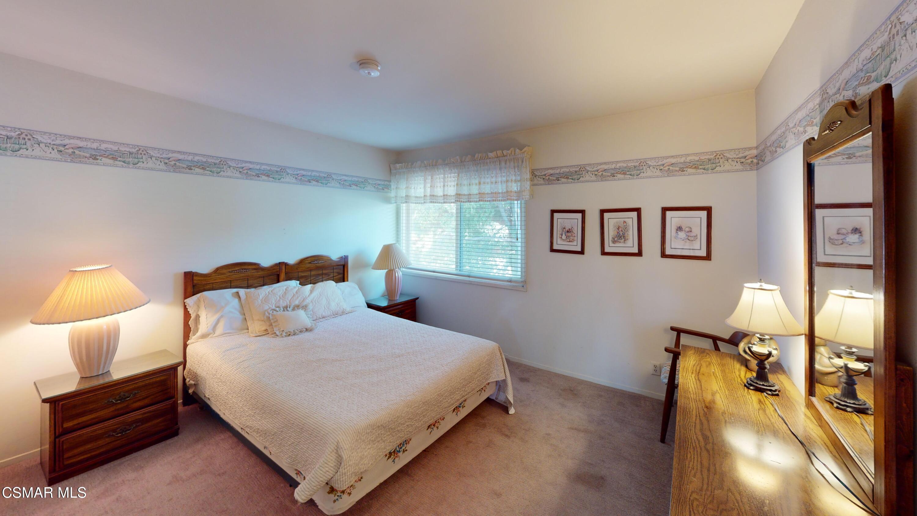 10900 Des Moines Avenue Porter Ranch, CA 91326 - Photo 21 of 38 a bedroom with a bed and wooden floor