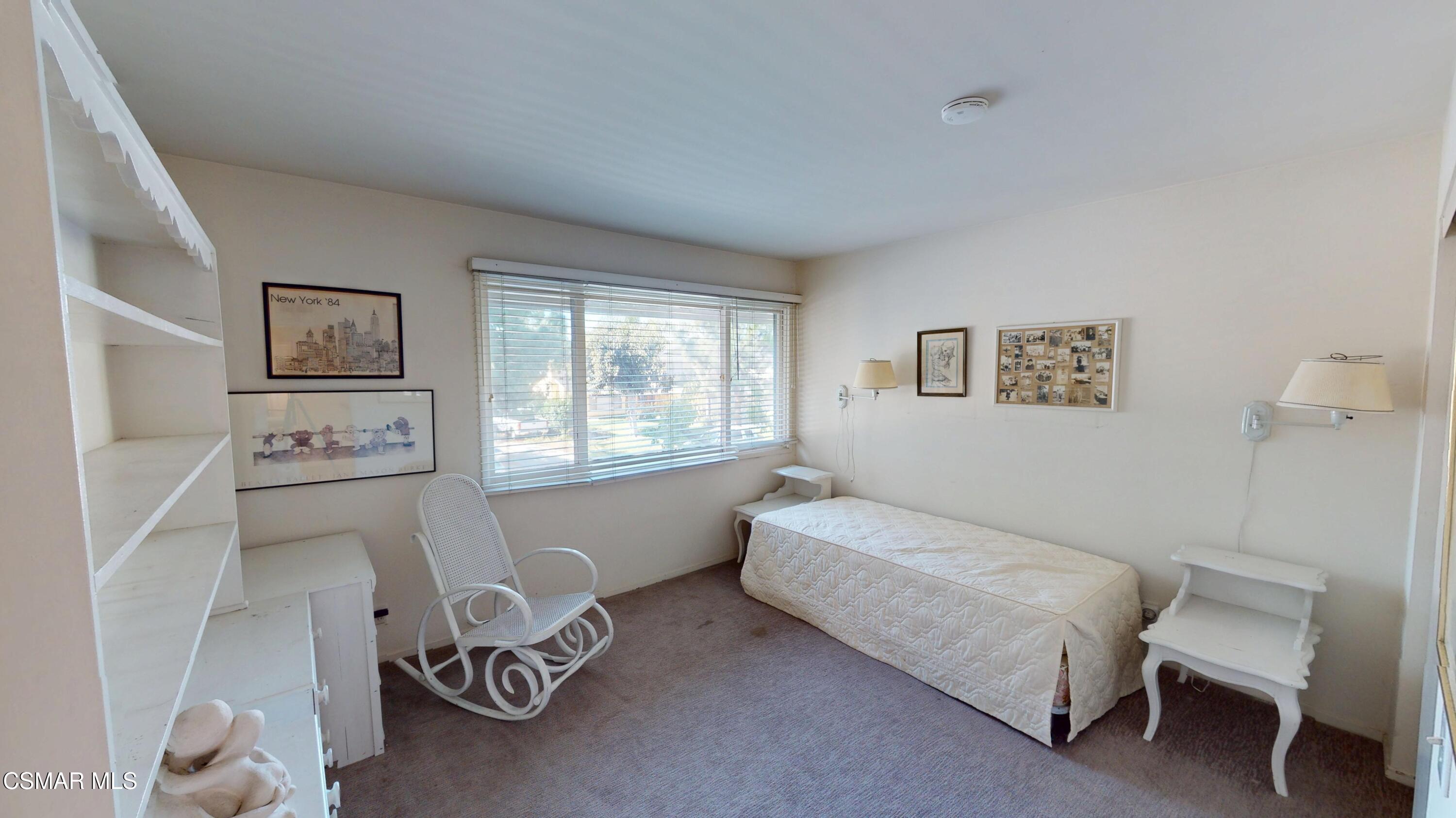 10900 Des Moines Avenue Porter Ranch, CA 91326 - Photo 23 of 38 a bedroom with a bed and a chair