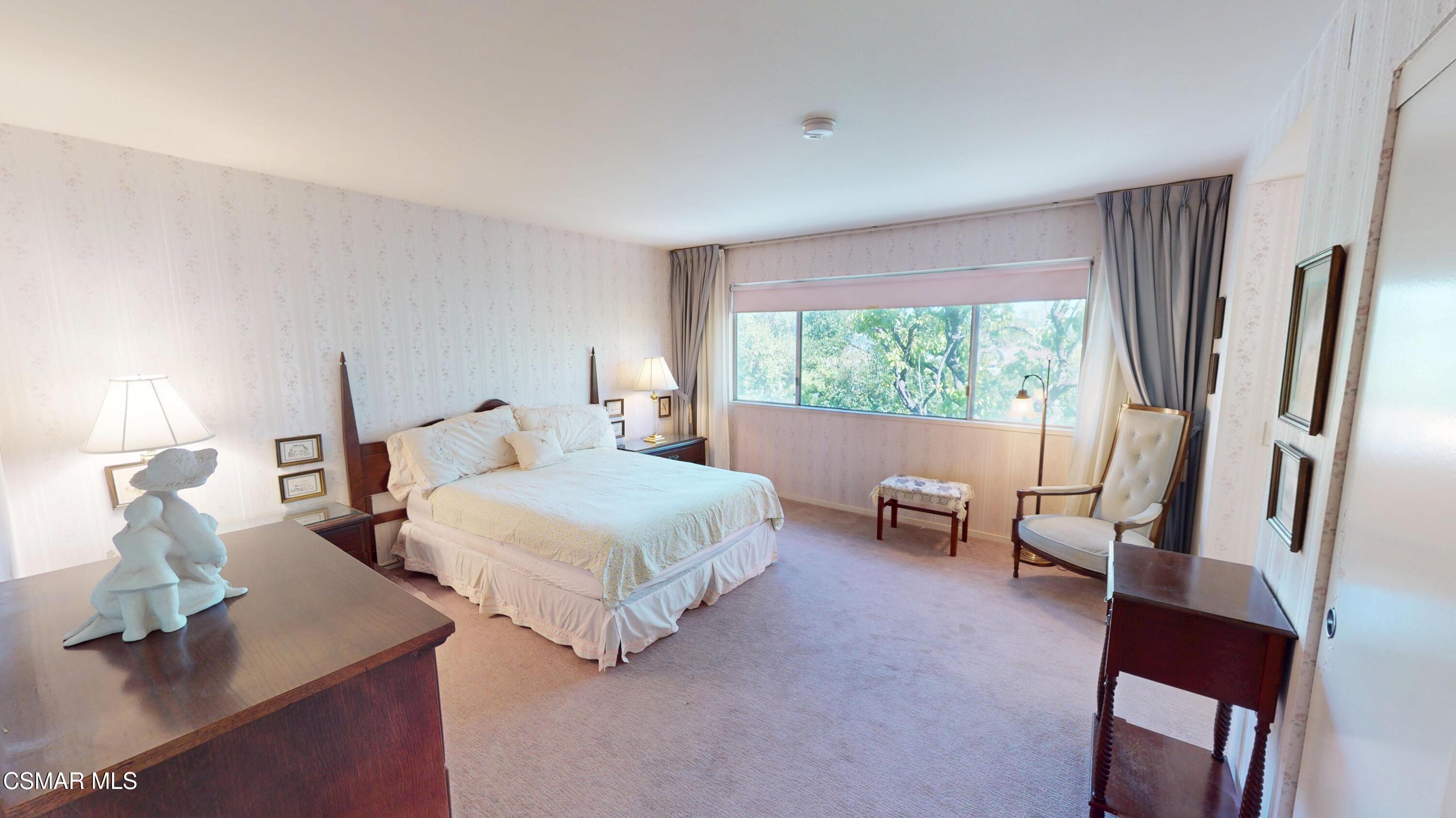 10900 Des Moines Avenue Porter Ranch, CA 91326 - Photo 26 of 38 a bedroom with a bed and large mirror